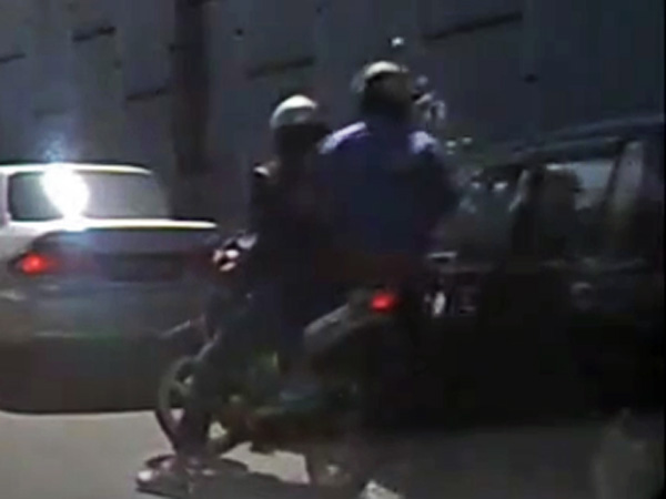 Motorbike smashes car window